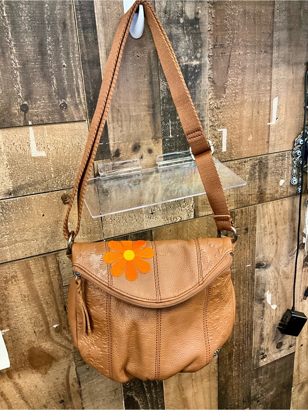 The Sak Tan Crossbody with Orange Flower Accent